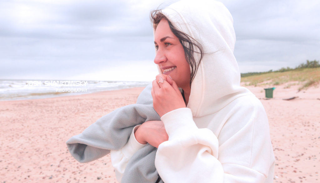 A girl sits by the Baltic sea