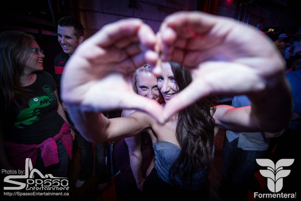 A girl makes the heart sign at a Spasso Entertainment Event. Taken by event photographer Josh Shankowsky